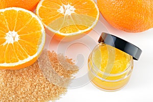 Natural orange sugar lip scrub on white.