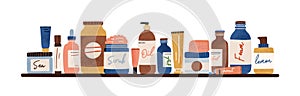 Natural organic cosmetic standing on shelf. Bottles, jars, tubes of lotion, cream, oil, scrub, serum, gel in eco