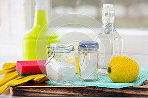 Natural organic eco friendly home cleaning tools ingredients, white vinegar, lemon, baking soda, citric acid.