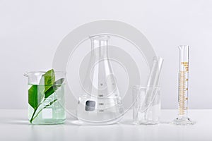 Natural organic extraction and green herbal leaves, Scientific glassware