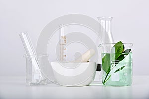 Natural organic extraction and green herbal leaves, Scientific glassware