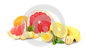 Natural, organic, fresh citrus fruits: orange, grapefruit, and banana with green leaves of mint isolated on a white background.