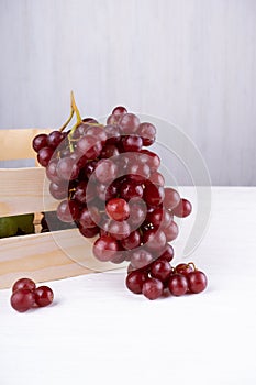 Natural organic juicy grapes set, red and green fruits in wooden box, on white background