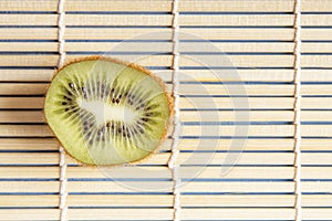 Natural organic kiwi fruits on bamboo mat for healthy breakfast and dinner. Copy space. Chinese and japanese kitchen concept. Top