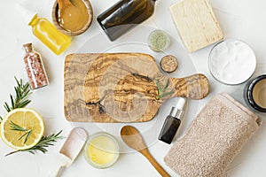 Natural organic skincare products with bath salt, oil, balm, lemon, honey for skin treatments, wooden board copy space