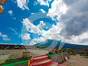 natural painting of a mountain covered in white clouds