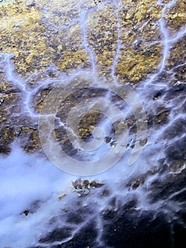 Natural painting of a stone wall in a cave. Formation of rock paintings.