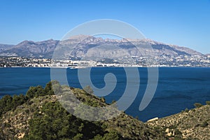 Natural park `Serry Gelada` with view to Altea under mountainrange and ruin of ocher mine along the coast of Albir, Spain