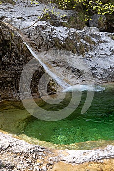 Natural path of Val Falcina at Valle del Mis in Italy. Cadini of Brenton, Sospirolo, with blue azure clear water and multiple