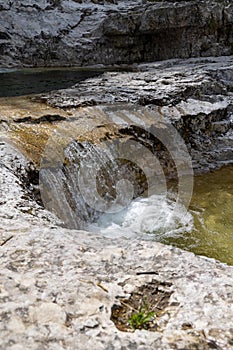 Natural path of Val Falcina at Valle del Mis in Italy. Cadini of Brenton, Sospirolo, with blue azure clear water and multiple