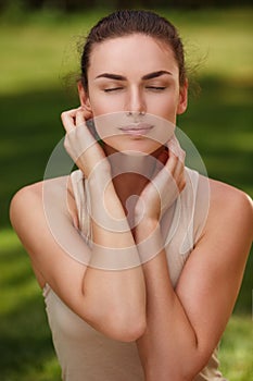 Natural peaceful portrait of a beautiful girl with pure skin relax outdoors