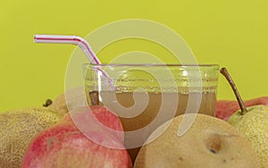 Natural pear juice and fruits of different varieties on yellow background photo