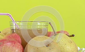 Natural pear juice and fruits of different varieties on yellow background photo