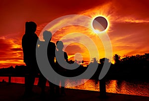 Natural phenomenon. Three looking at looking at total solar eclipse.