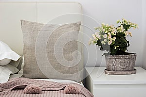 Natural pillow on bed in a cozy bedroom, Mockup