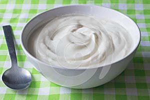 Natural plain white Greek yoghurt in bowl closeup - Yogurt background