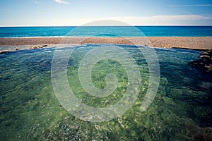 Natural pool and river in front of the sea, on Playa San Rafael, Dominican Republic