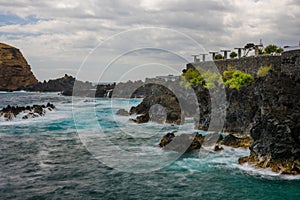 Natural pools with black volcanic rock in the Atlantic Ocean Porto Moniz, Madeira, Portugal