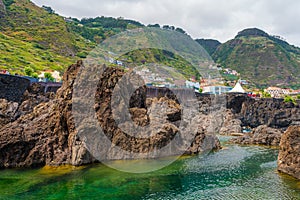 Natural pools with black volcanic rock in the Atlantic Ocean Porto Moniz, Madeira, Portugal