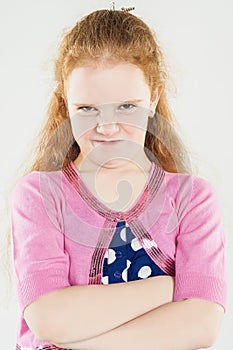 Natural Portrait of Caucasian Red-haired Angry Little Girl with