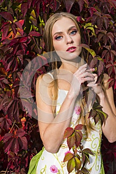 Natural Portrait of Sensual Caucasian Blond Woman Posing in Light Dress With Ivy Oiutdoor