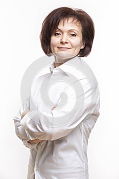 Natural Portrait of Smiling Mature Confidant Brunette Caucasian Business Woman in Whitre Shirt Posing With Hands Folded On White