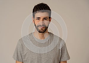 Natural portrait of young attractive man in his 20s looking and posing with neutral face expression photo