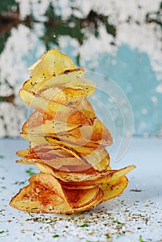 Natural potato chips with sea salt on a light background. Diet.