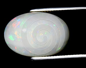 natural rainbow multi color opal gem on the background