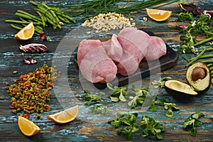 Natural raw ingredients for healthy food on rough dyed wooden background.