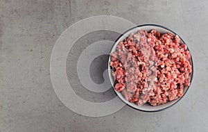 Natural raw ingredients for pet food on grey background.