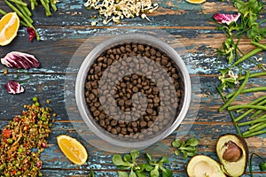 Natural raw ingredients for vegan special pet food on rough dyed wooden background.