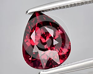 natural red rhodolite garnet gem on the background photo