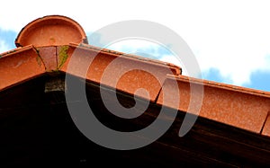 Detail of the red tile roof under blue sky with cloud  2 photo