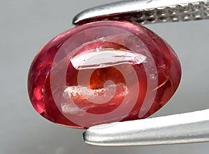 natural red spinel gem on the background