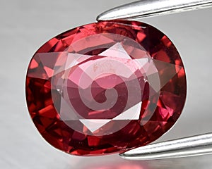 natural red spinel gem on the background