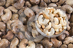 Natural and roasted cashew nut on wooden background - Anacardium occidentale photo