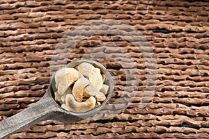 Natural and roasted cashew nut on wooden background - Anacardium occidentale photo