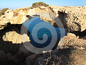 Natural rock arch surrounded by the sea in Cape Greco National Forest Park in Cyprus