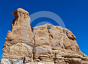 Natural rock formation with a hole along Notom Road in the Grand Staircase-Escalante National Monument, Utah, USA