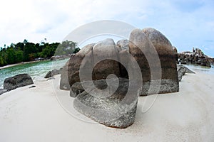 Natural rock formation in the sea and on a white sand beach in Belitung Island.