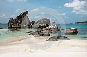 Natural rock formation in the sea and on a white sand beach in Belitung Island, Indonesia.