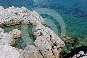 Natural rock pool on the rocky Mediterranean shores of Aegean Sea in Aquairum Bay, Turkey.