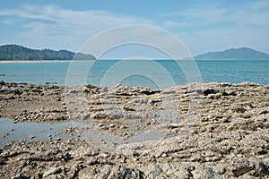Natural rocks on the beach with blue sky and cloud