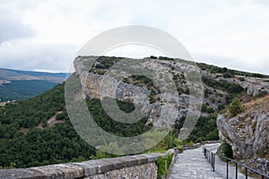 Natural rocks of the National Monument Ojo Guarena and walking path to access to the caves. Merindades, Burgos, Spain photo