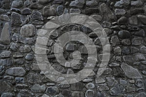 natural round stone wall background Rock and rounded stone wall texture with Old brick stone fence backdrop. front view