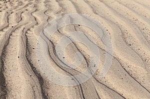 Natural sand pattern created by a flow of tide and ripples