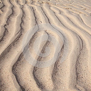 Natural sand pattern created by a flow of tide and ripples