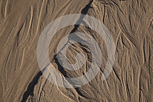 Natural sand pattern created by a flow of tide and ripples