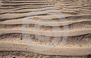 Natural sand pattern created by a flow of tide and ripples
